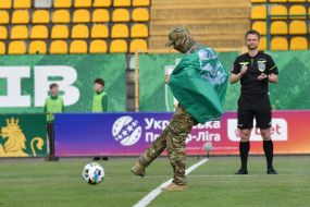A serviceman makes the first symbolic kick at the ball