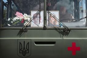 Photos of sisters Lyubava and Vera Yakovlev behind the windshield of a military vehicle