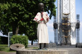 Monument to the "girl with spikelets" in an embroidered shirt