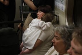Woman holding a child in an embroidered dress