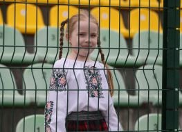 A young fan - a girl in an embroidered shirt