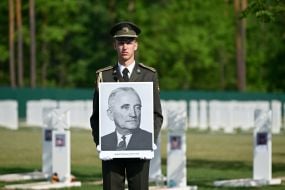 A soldier from the honor guard company holds a photo of OUN leader Andriy Melnyk
