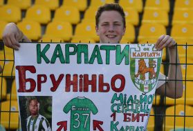 A boy fan holds a poster in support of Bruninho
