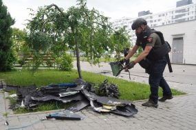 A sapper near the wreckage of a Russian drone.