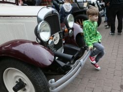 Boy standing near motorcycles