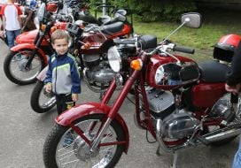 Boy standing near motorcycles