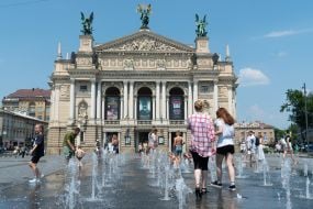 Люди охолоджуються у фонтані біля Оперного театру у Львові