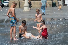 Children cool off in a fountain near the Opera House in Lviv