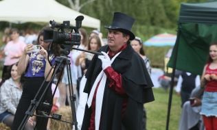 Cameraman near a video camera in a retro costume
