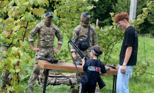 Military personnel from the 32nd Military District show guests of the "Retro Wave" Youth Festival modern small arms