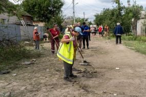 Municipal workers and local residents clean up