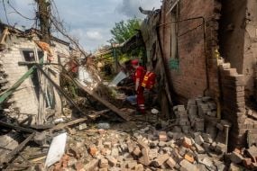 Medics work at the site of a Russian small-sized cruise missile “Banderol” hitting a private house