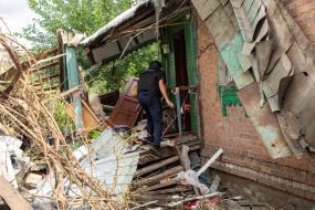 Rescuers work at the site of a Russian small-sized cruise missile “Banderol” hitting a private house