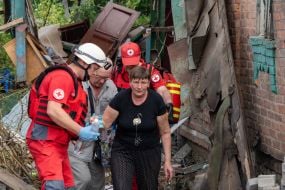 Medics provide assistance to victims after a Russian small-sized cruise missile, Banderol, hit a private house