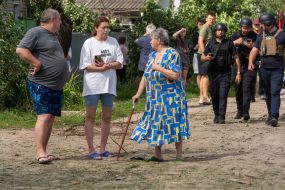 Local residents near a private house destroyed after being hit by a Russian small-sized cruise missile Banderol