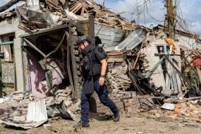 Rescuers work at the site of a Russian small-sized cruise missile “Banderol” hitting a private house