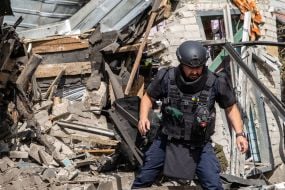 Rescuers work at the site of a Russian small-sized cruise missile “Banderol” hitting a private house