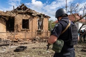 Rescuers work at the site of a Russian small-sized cruise missile “Banderol” hitting a private house