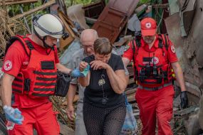 Medics provide assistance to victims after a Russian small-sized cruise missile, Banderol, hit a private house