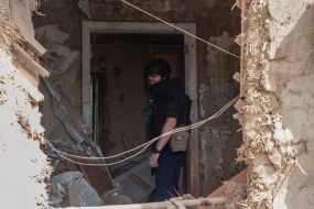 Rescuers work at the site of a Russian small-sized cruise missile “Banderol” hitting a private house