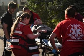 Medics provide assistance to victims after a Russian missile hit a residential building in Lviv