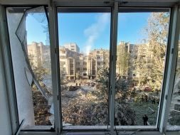 View from a broken window of a neighboring house on a residential building damaged by a missile strike in Lviv