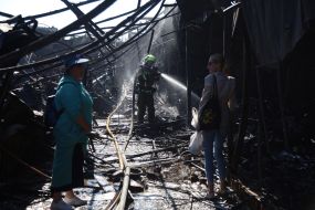 Firefighters and rescuers are eliminating the consequences of a rocket strike on the antique flea market on Pochaina Street in Kyiv