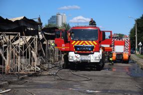 Firefighters and rescuers are eliminating the consequences of a rocket strike on the antique flea market on Pochaina Street in Kyiv