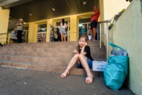 A girl evacuated from the Shevchenkivska community of the Kupyanskyi district sits on the stairs at the IDP reception point in Kharkiv