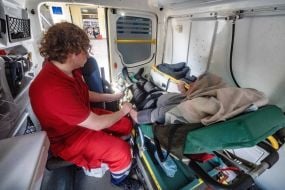 A medic provides assistance to a man evacuated from the Shevchenkivsk community of the Kupyansk district in an ambulance