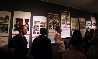 Visitors inspect the exhibition exhibits