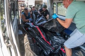 Bodies of those killed in the rocket attack on the village of Pechenigy