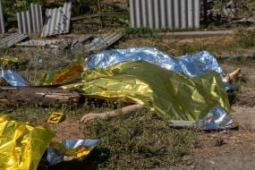Bodies of those killed in the rocket attack on the village of Pechenigy