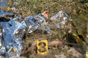 Bodies of those killed in the rocket attack on the village of Pechenigy