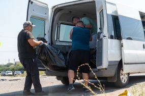 Bodies of those killed in the rocket attack on the village of Pechenigy