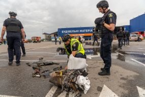 Police officers near fragments of a Russian drone