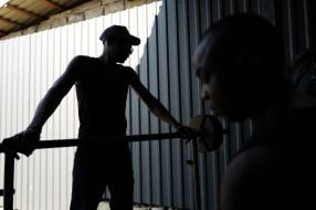 A prisoner of war lifts a barbell in one of the special camps for holding Russian prisoners of war
