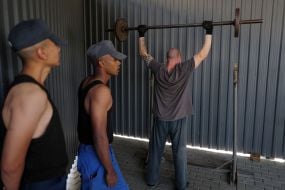 A prisoner of war lifts a barbell in one of the special camps for holding Russian prisoners of war
