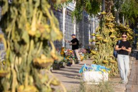 People near the Wall of Remembrance of the Fallen Defenders of Ukraine