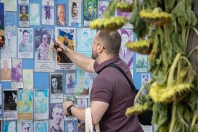 People near the Wall of Remembrance of the Fallen Defenders of Ukraine