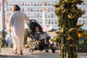 People near the Wall of Remembrance of the Fallen Defenders of Ukraine