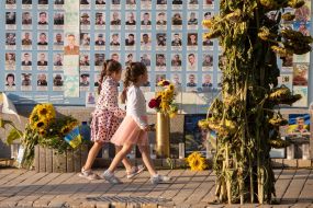 People near the Wall of Remembrance of the Fallen Defenders of Ukraine