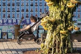 People near the Wall of Remembrance of the Fallen Defenders of Ukraine