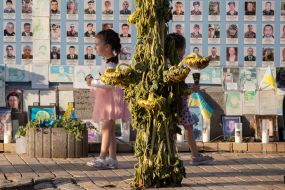 People near the Wall of Remembrance of the Fallen Defenders of Ukraine