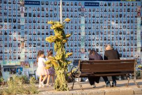 People near the Wall of Remembrance of the Fallen Defenders of Ukraine