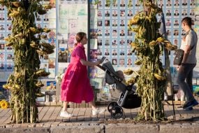 People near the Wall of Remembrance of the Fallen Defenders of Ukraine