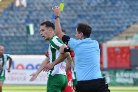 The referee shows a yellow card.