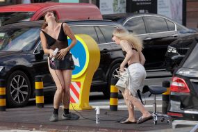 A hairdresser styles a young woman's hair in the center of Kyiv