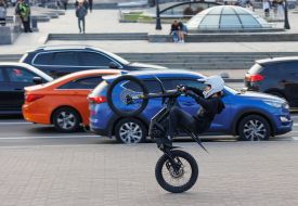 A guy is performing stunts on a motorcycle.