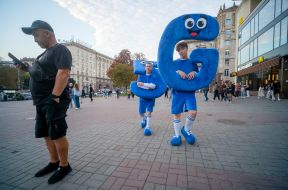 Young people in costumes featuring a large "5G" letter and number.